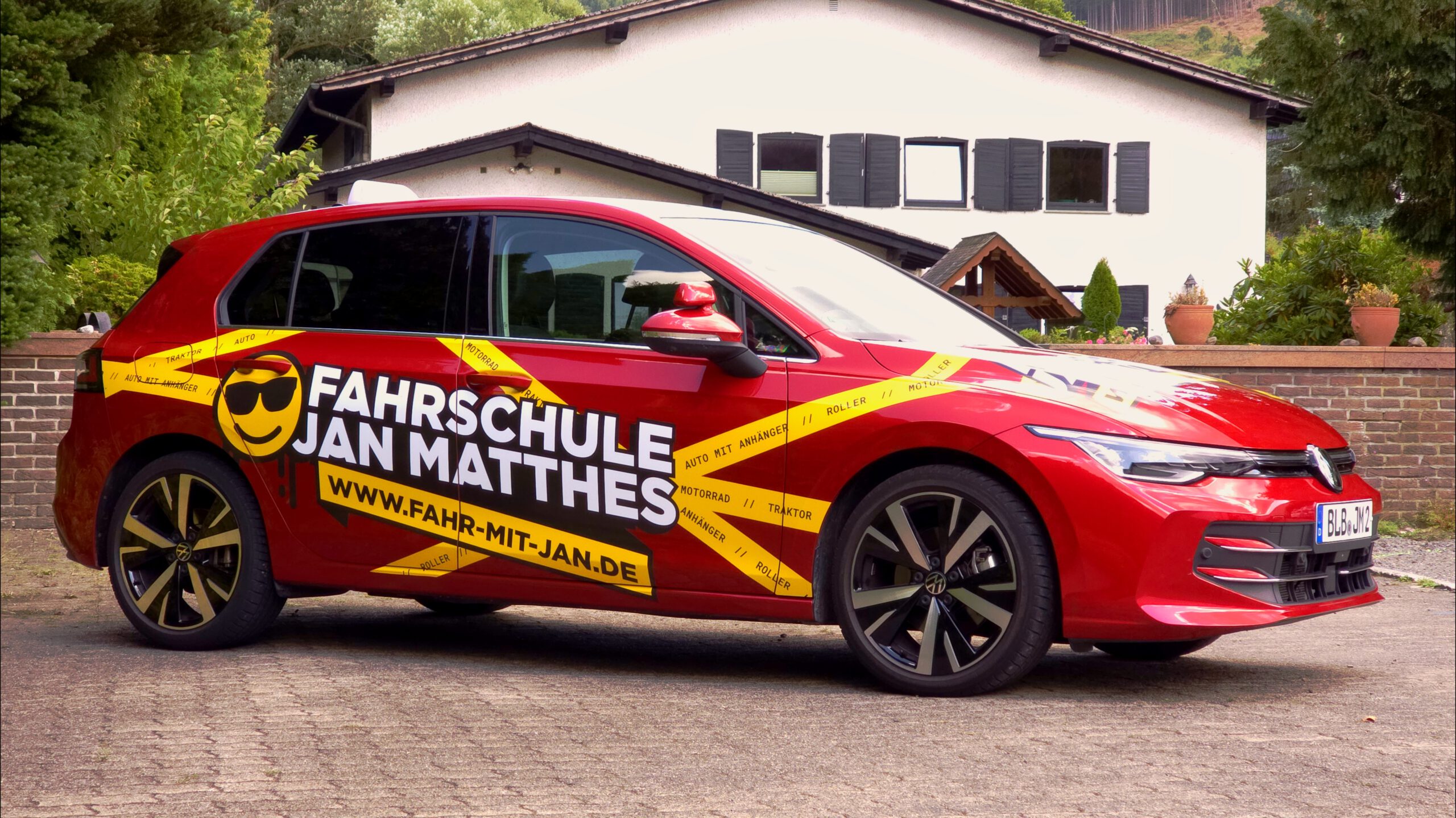 Seitenansicht des roten VW Golf 8 Fahrschulautos der Fahrschule Jan Matthes in Bad Berleburg für die Klassen B und BE
